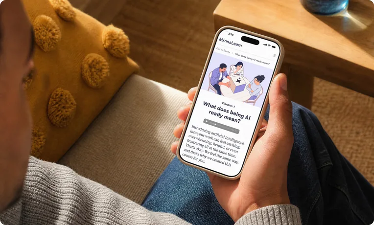Hand holding a phone that shows a MinnaLearn course chapter